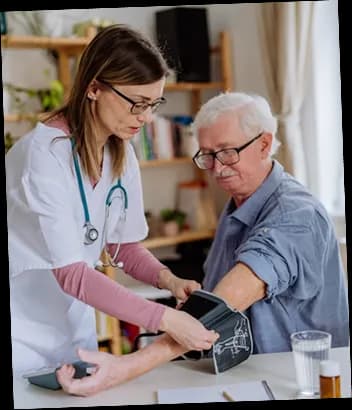 Nurse smiling warmly with elderly patient